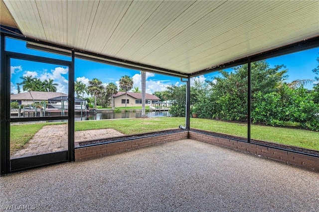 unfurnished sunroom with a water view