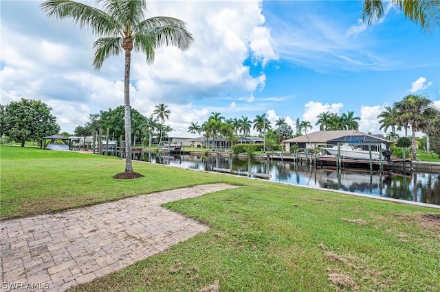 dock area with a water view and a yard