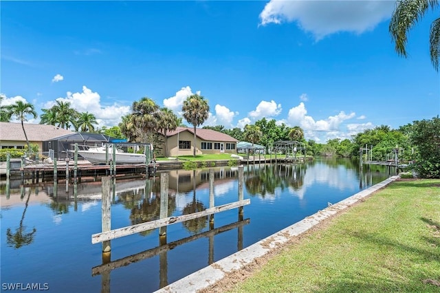 dock area featuring a lawn and a water view