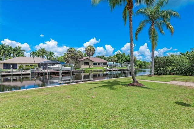 dock area with a yard and a water view