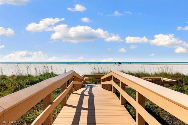 view of property's community featuring a water view and a view of the beach