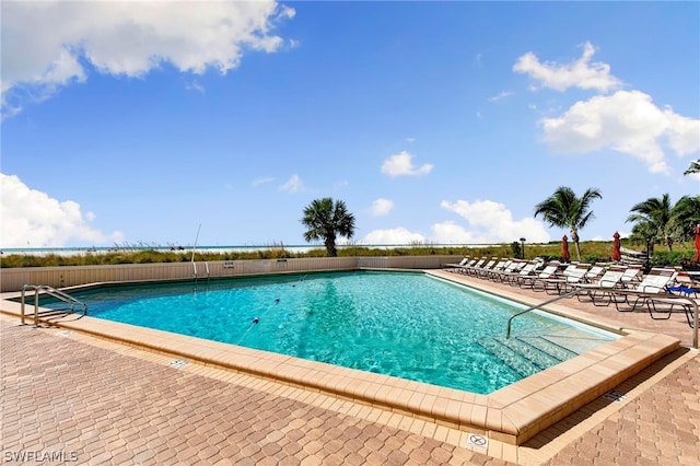 view of swimming pool featuring a patio area