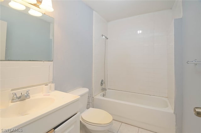 full bathroom with vanity, tile patterned floors, tile walls, tiled shower / bath, and toilet