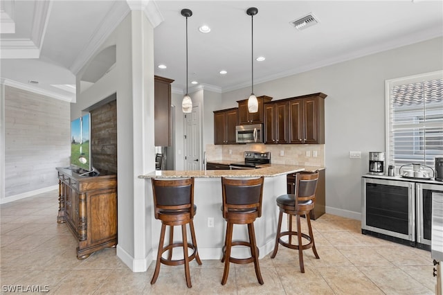 kitchen featuring light stone countertops, hanging light fixtures, wine cooler, appliances with stainless steel finishes, and ornamental molding