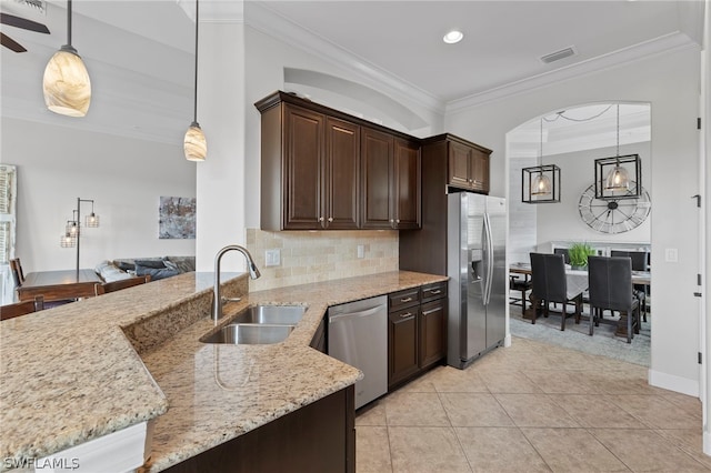 kitchen with dark brown cabinets, light stone counters, sink, and stainless steel appliances