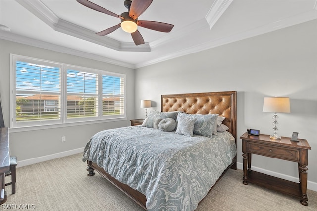 bedroom featuring a tray ceiling, ceiling fan, and crown molding