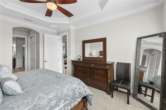 bedroom with a tray ceiling, ceiling fan, and ornamental molding