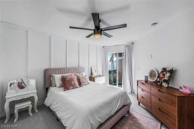 bedroom with access to exterior, a decorative wall, carpet floors, and ceiling fan