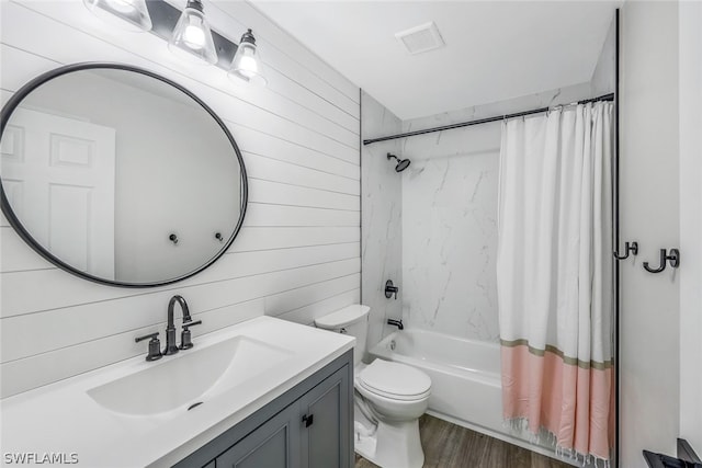 full bathroom featuring vanity, visible vents, shower / bath combination with curtain, wood walls, and toilet