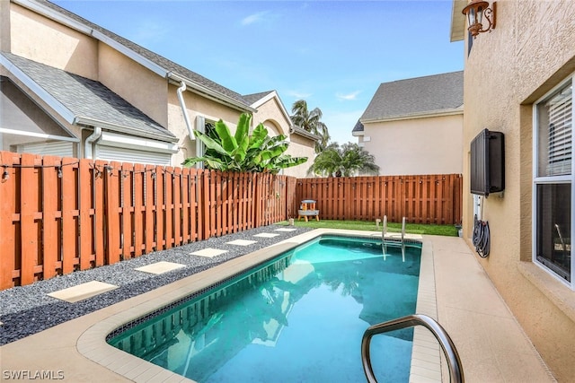 view of swimming pool with a fenced backyard