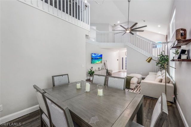 dining room with high vaulted ceiling, ceiling fan, and dark hardwood / wood-style flooring