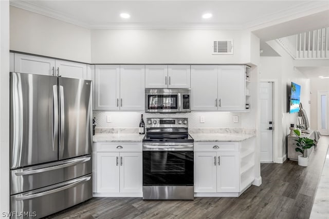 kitchen with white cabinets, stainless steel appliances, light stone counters, and dark hardwood / wood-style floors