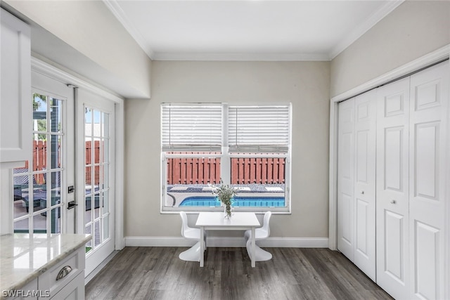 dining area featuring dark hardwood / wood-style flooring and ornamental molding