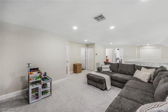 carpeted living area with recessed lighting, visible vents, and baseboards