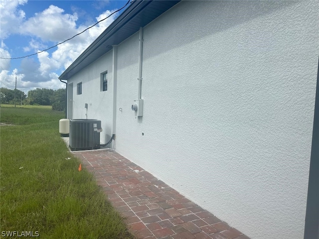 view of property exterior with central AC