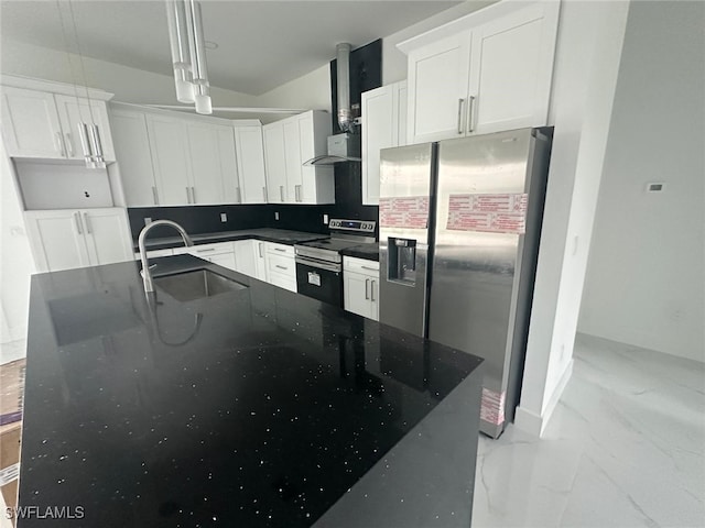 kitchen featuring appliances with stainless steel finishes, sink, hanging light fixtures, wall chimney exhaust hood, and white cabinets