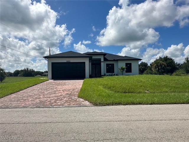 view of front facade with a front yard and a garage