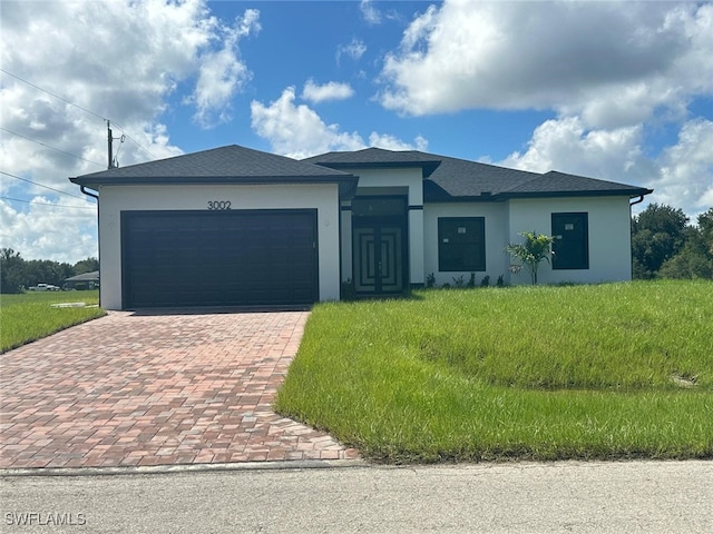 view of front of home featuring a front lawn and a garage