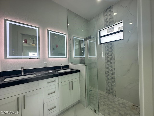 bathroom featuring vanity, plenty of natural light, and tiled shower