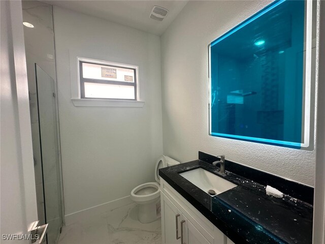 bathroom featuring toilet and vanity