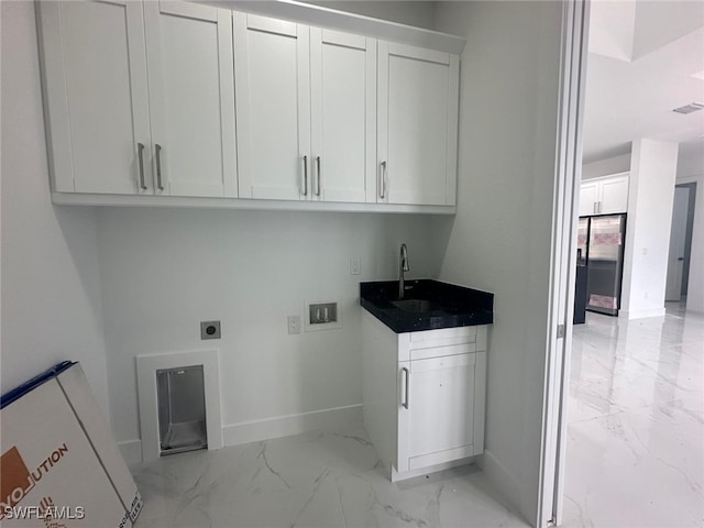 laundry room featuring sink, electric dryer hookup, washer hookup, and cabinets