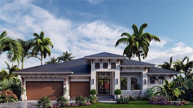 view of front facade featuring a garage, driveway, a standing seam roof, and metal roof