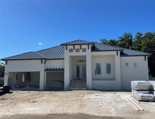 rear view of property with french doors