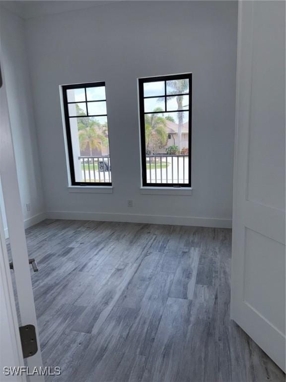 empty room featuring baseboards and wood finished floors