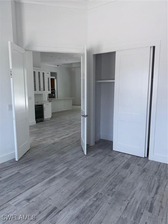 interior space featuring baseboards, a closet, and wood finished floors