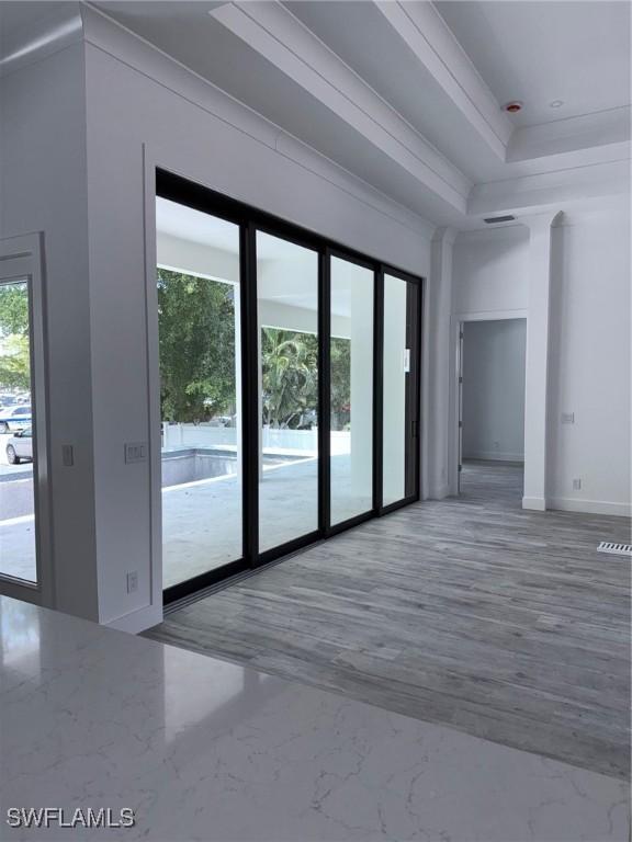 interior space featuring baseboards and a raised ceiling