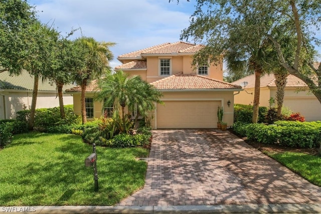 mediterranean / spanish home featuring a garage and a front lawn