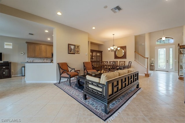 living room with light tile patterned floors and a chandelier