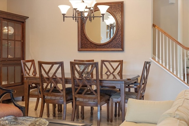 dining space with tile patterned floors and a notable chandelier