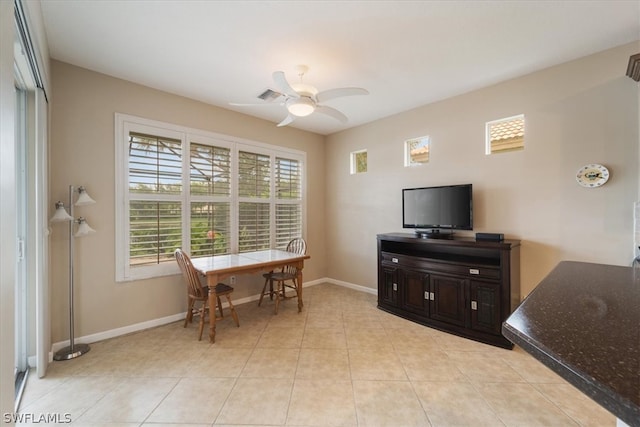 tiled dining room featuring a healthy amount of sunlight and ceiling fan