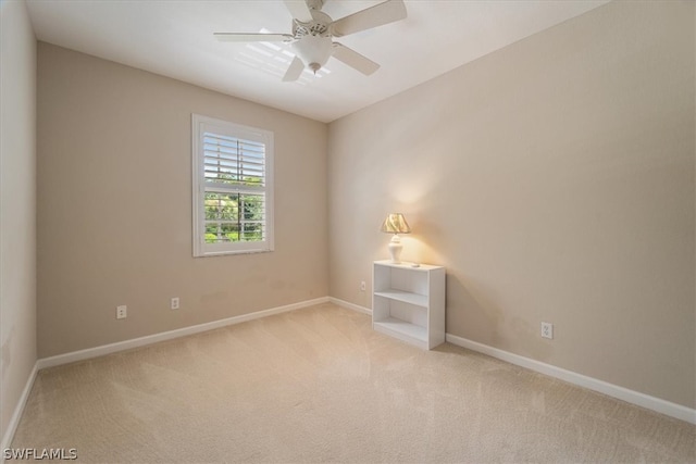 carpeted empty room featuring ceiling fan