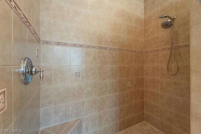 bathroom with a tile shower