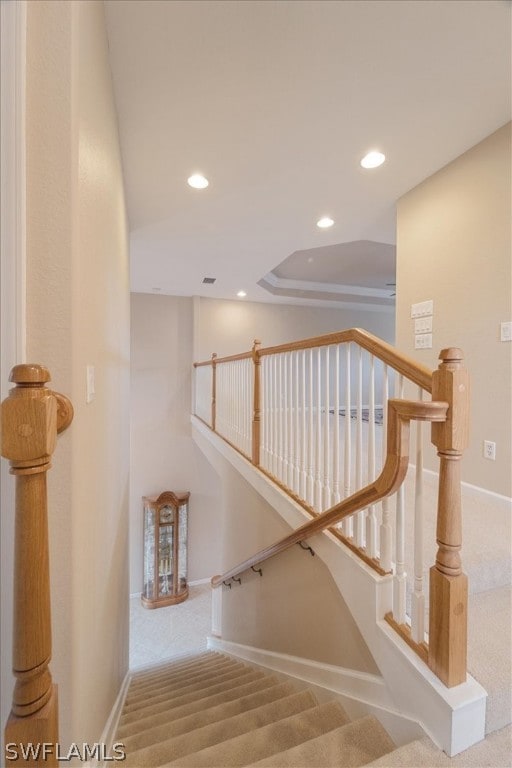 stairway featuring carpet