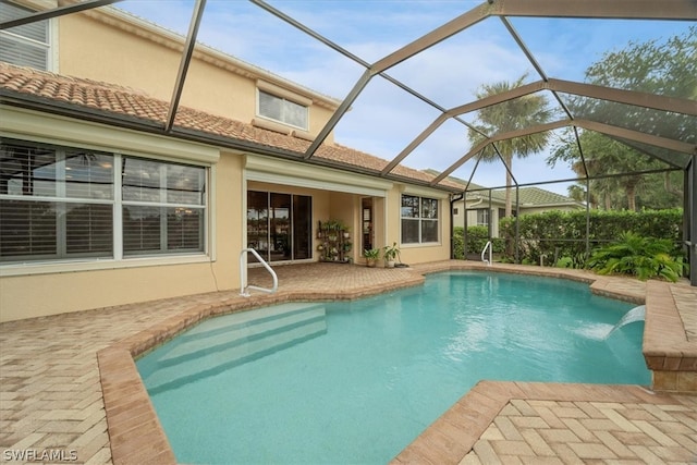 view of pool with a patio area and a lanai