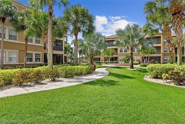 view of property's community with a lawn