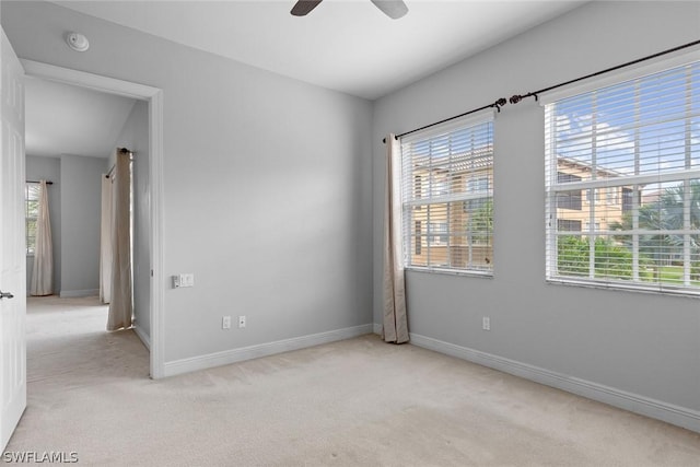 empty room with light colored carpet and ceiling fan