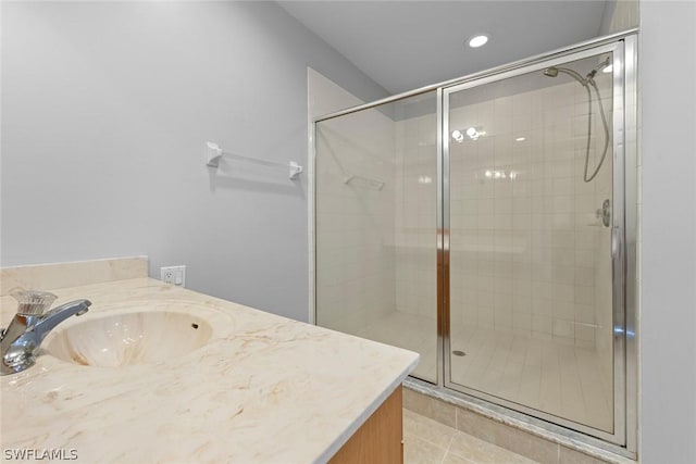 bathroom featuring tile patterned floors, vanity, and an enclosed shower