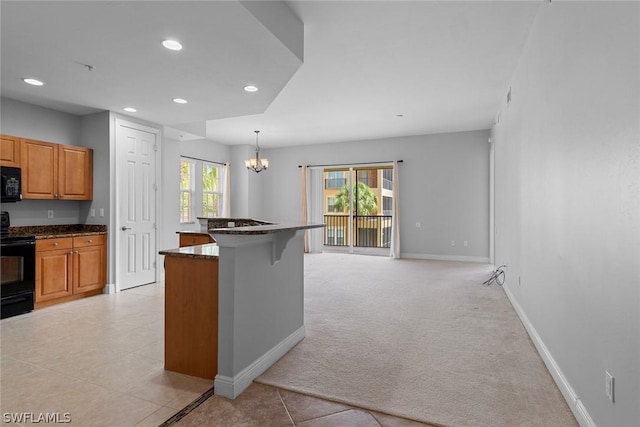 kitchen with a breakfast bar, a notable chandelier, light carpet, black appliances, and decorative light fixtures