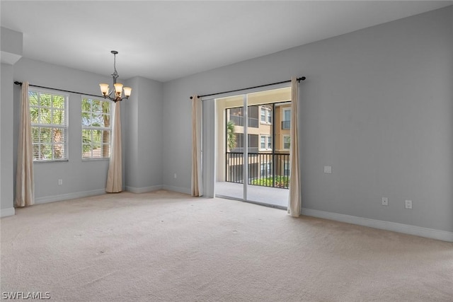 unfurnished room with light colored carpet and a notable chandelier