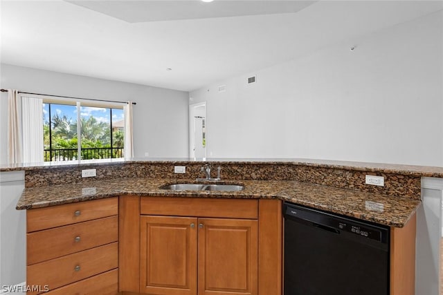 kitchen featuring black dishwasher, dark stone countertops, and sink