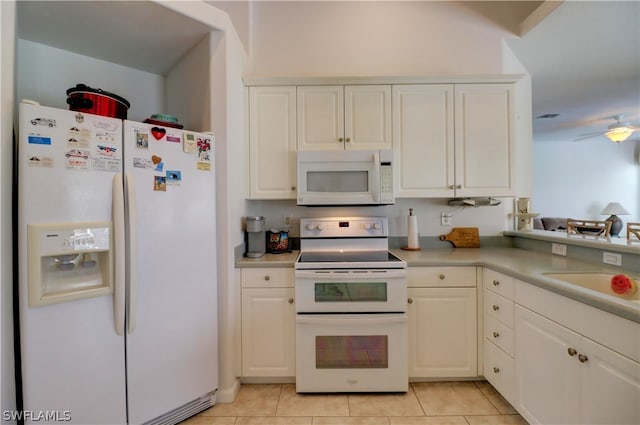 kitchen with white appliances, white cabinets, sink, light tile patterned flooring, and ceiling fan