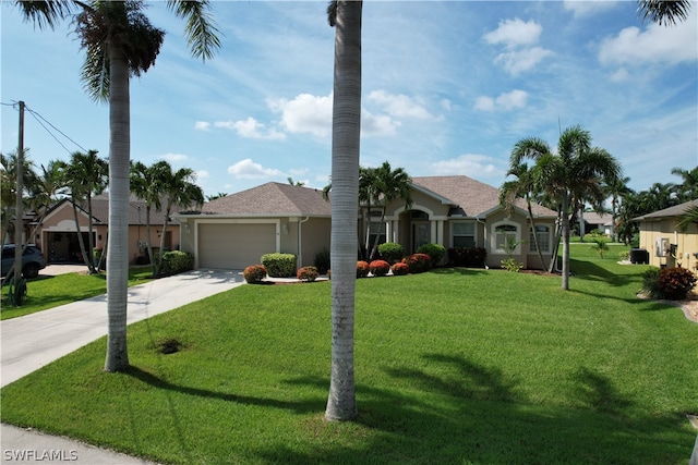 single story home featuring a garage and a front lawn