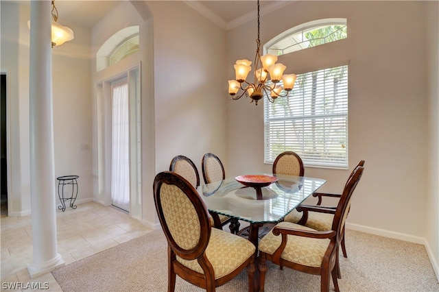 tiled dining space featuring decorative columns, ornamental molding, and a notable chandelier