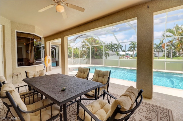 view of pool with a patio, ceiling fan, and a lanai