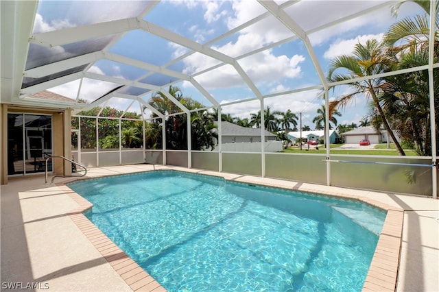 view of swimming pool with a patio and glass enclosure