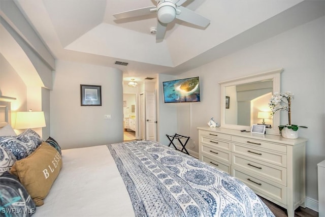 bedroom featuring ceiling fan, connected bathroom, and a raised ceiling